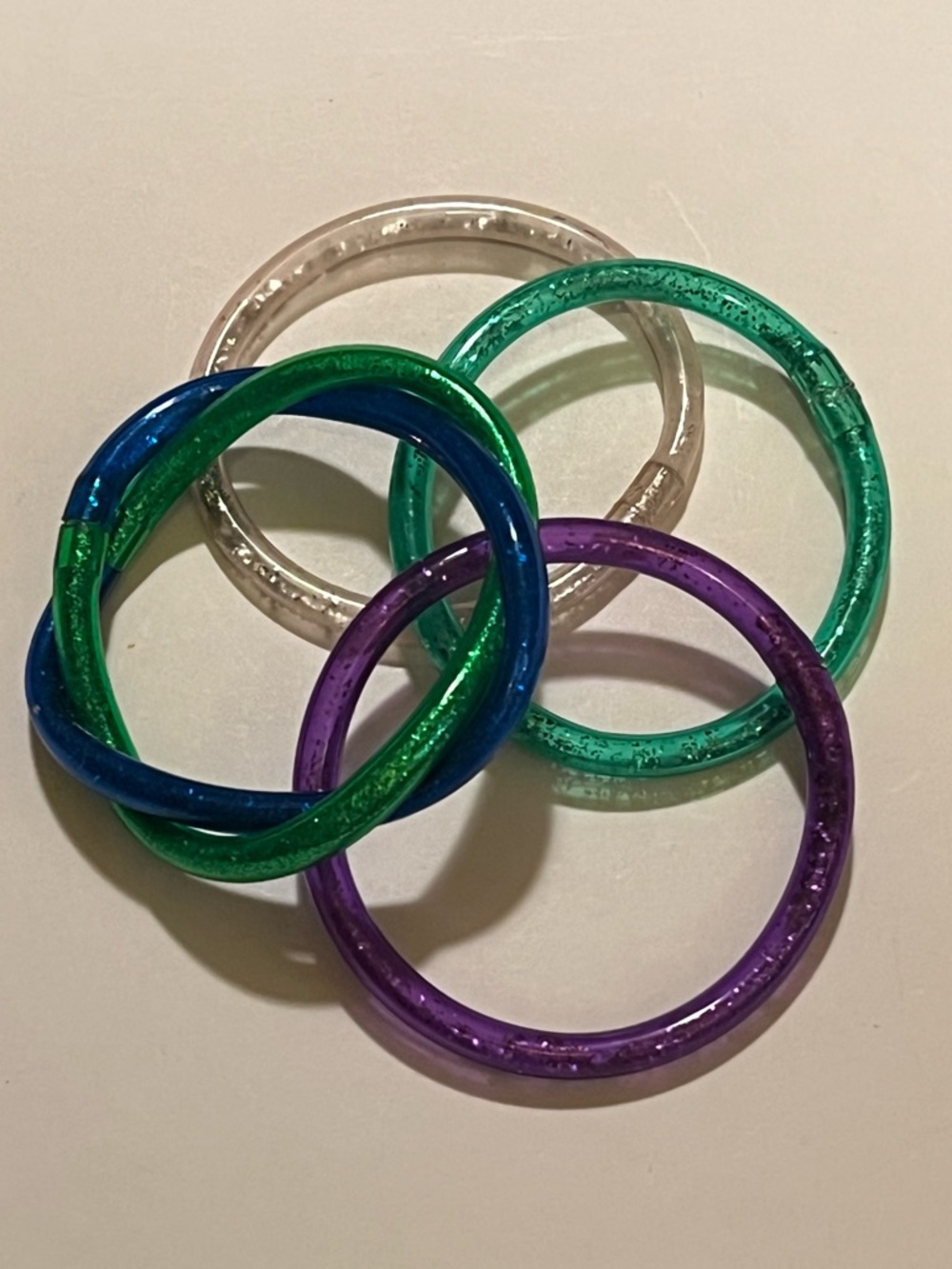 LOT OF 4 KID’S COLORFUL JELLY BRACELETS.